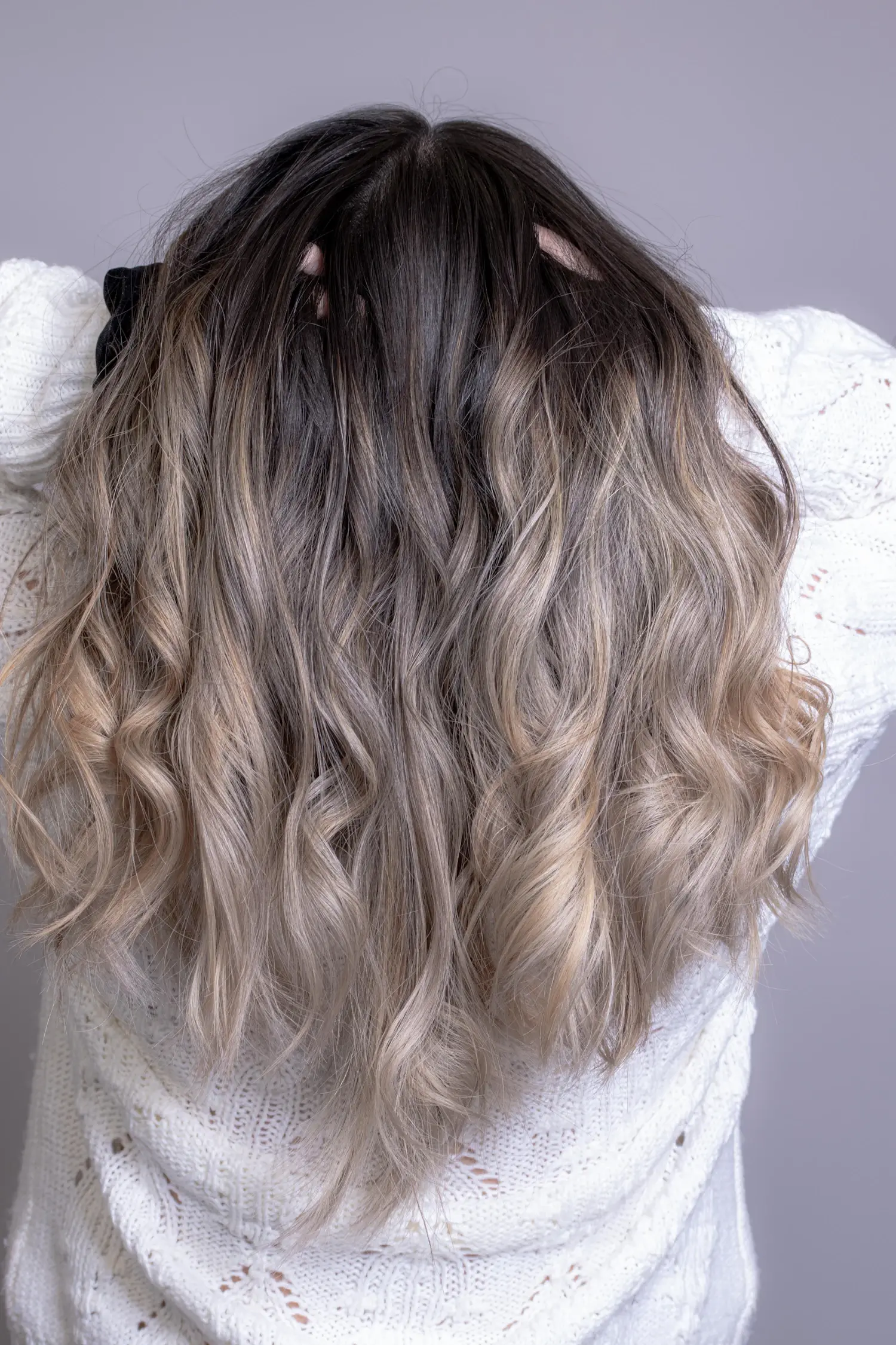 Soft ash-blonde waves seen from behind