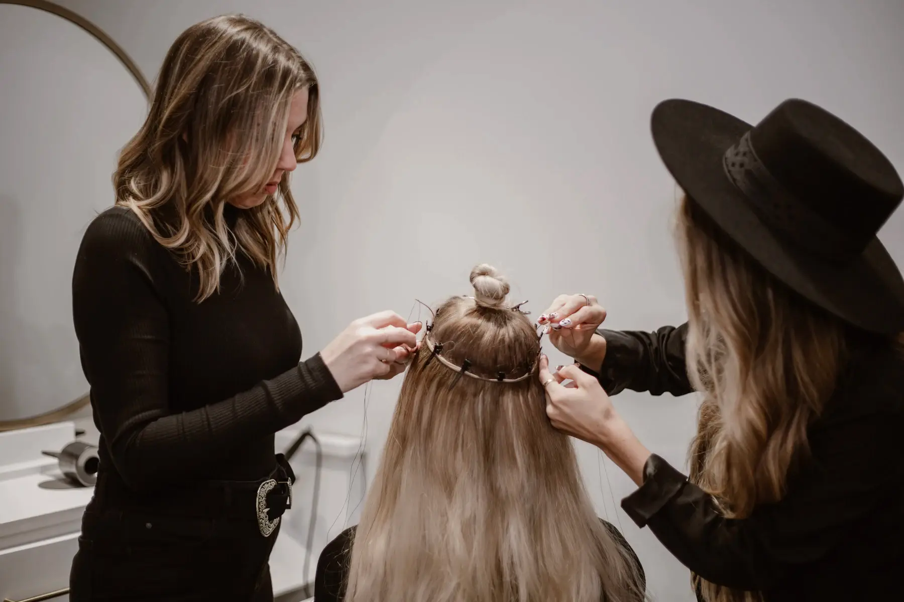 Stylists working hands-on with a model’s hair