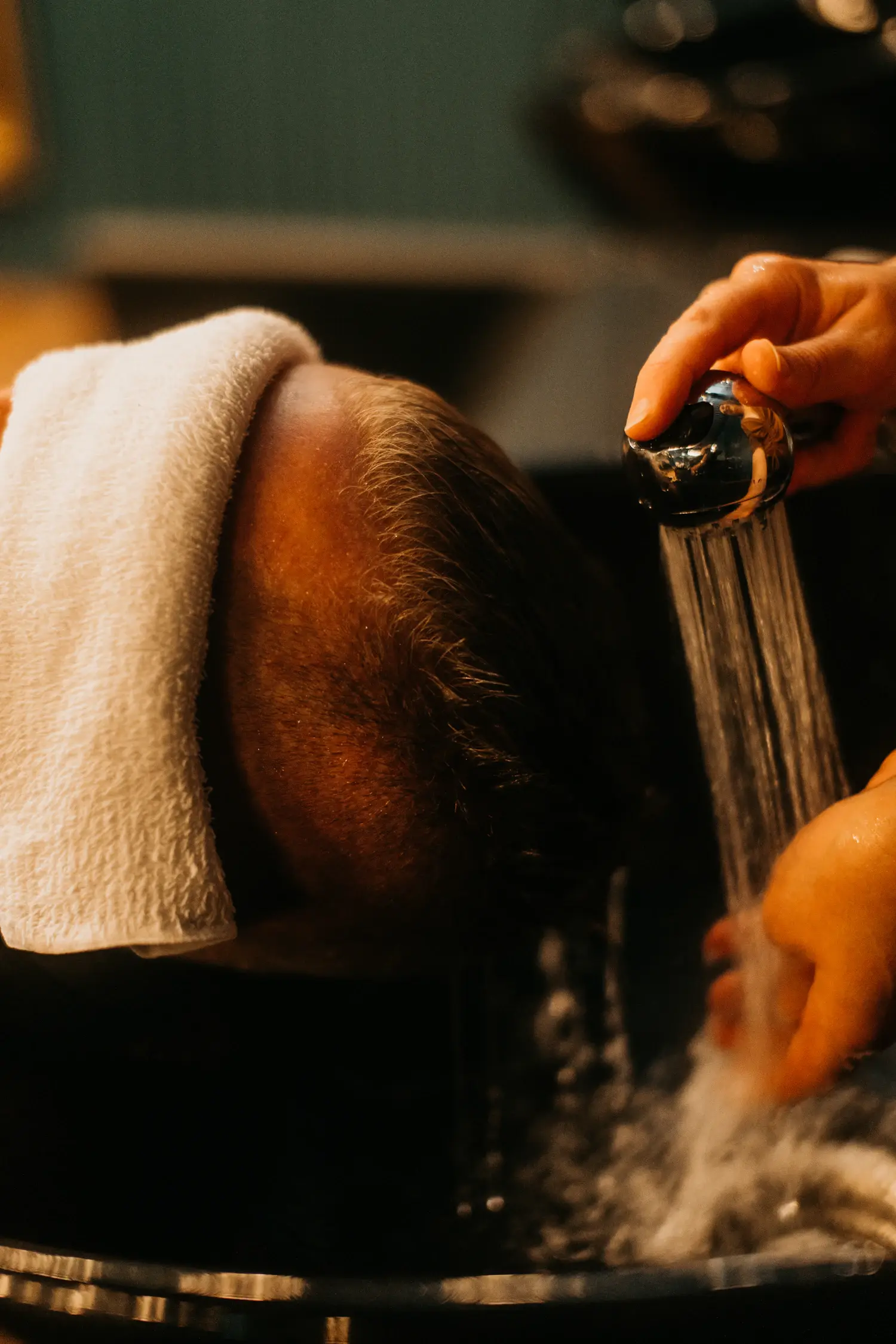 Warm water rinse at the shampoo basin
