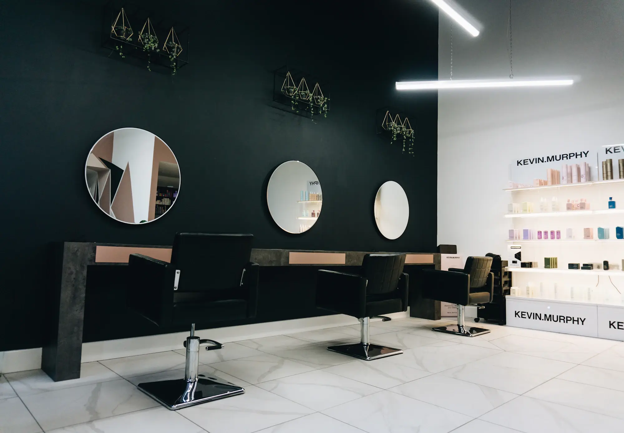 Salon chairs facing round mirrors
